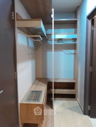 Spacious walk-in closet with wooden shelves and modern design