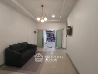 Spacious living room with modern lighting and sliding glass doors leading to patio.