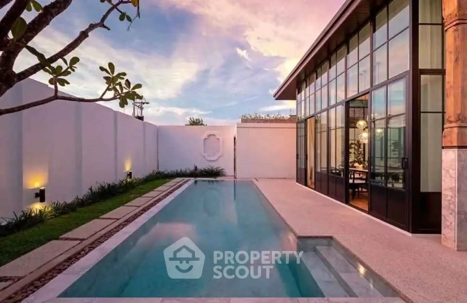 Luxurious modern villa with private pool and stunning sunset view, perfect for relaxation and entertainment.