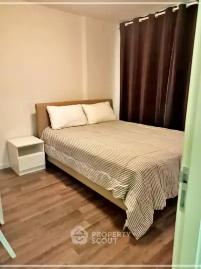 Cozy bedroom with modern decor and wooden flooring, perfect for relaxation.