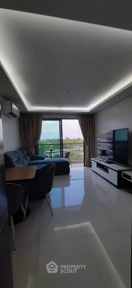 Modern living room with sleek design and stunning view from large windows.