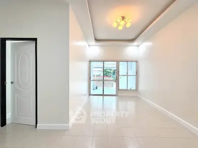 Spacious living room with elegant lighting and large windows for natural light.