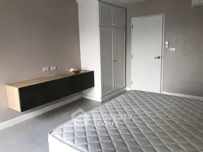 Spacious bedroom with modern design and built-in storage solutions.