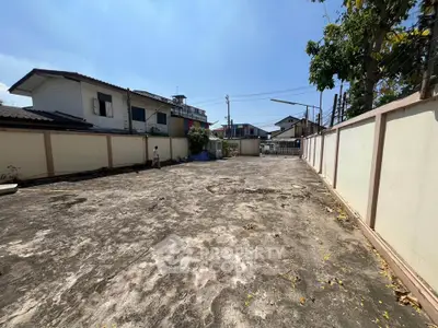 Spacious outdoor area with potential for development in a residential neighborhood.