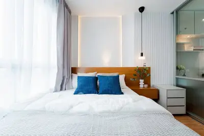 Modern bedroom with stylish decor and natural light