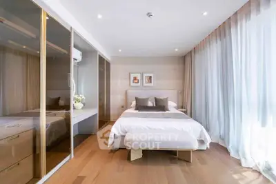 Elegant bedroom with wooden flooring, large windows, and modern decor in a luxury apartment.
