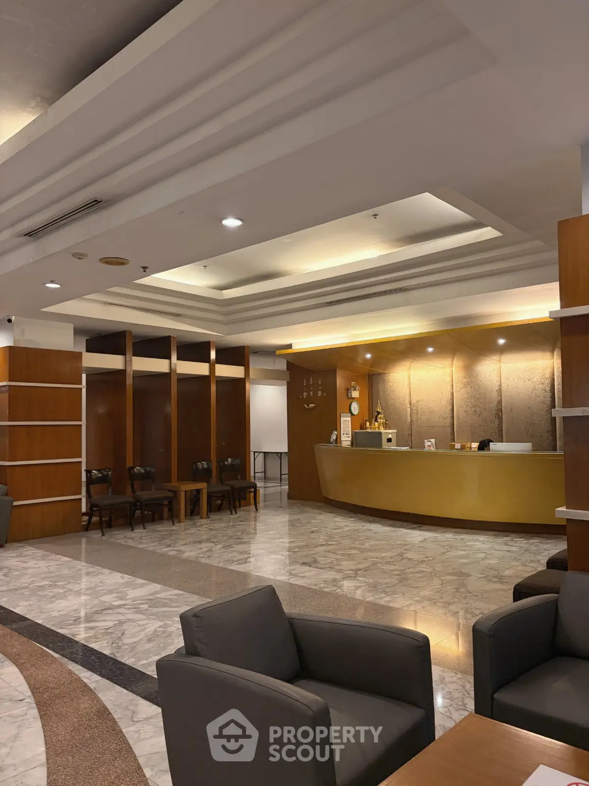 Elegant lobby with modern design and comfortable seating in a luxurious building.