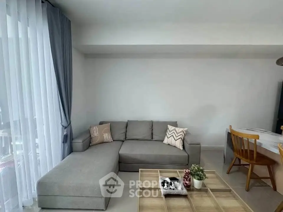 Modern living room with gray sectional sofa and stylish decor