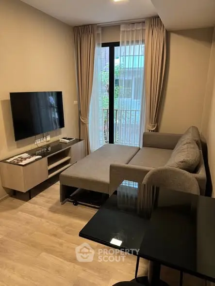 Modern living room with sleek furniture and large TV, perfect for relaxation.