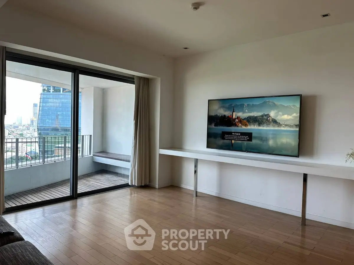 Spacious living room with balcony and scenic city view