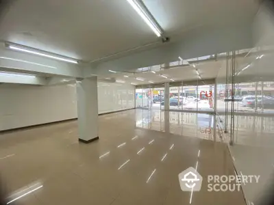 Spacious commercial property with large windows and tiled flooring in prime location.