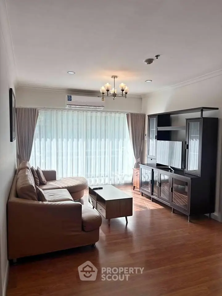 Spacious living room with elegant furniture and natural light, perfect for relaxation and entertainment.