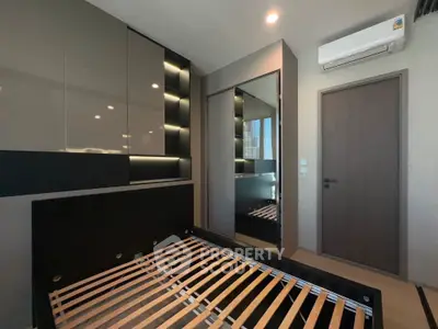 Modern bedroom with sleek built-in wardrobe and air conditioning unit