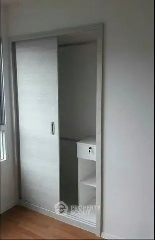 Compact storage space with sliding door in modern apartment