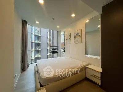 Modern bedroom with large windows and stylish decor in urban apartment