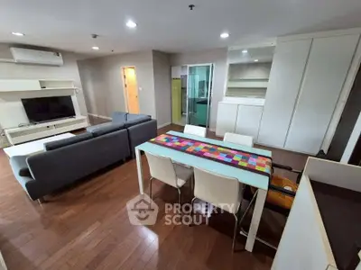 Spacious modern living room with sleek furniture and hardwood floors in a stylish apartment.