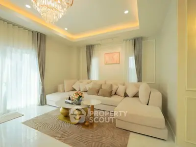 Luxurious living room with elegant chandelier and plush sectional sofa in modern home.