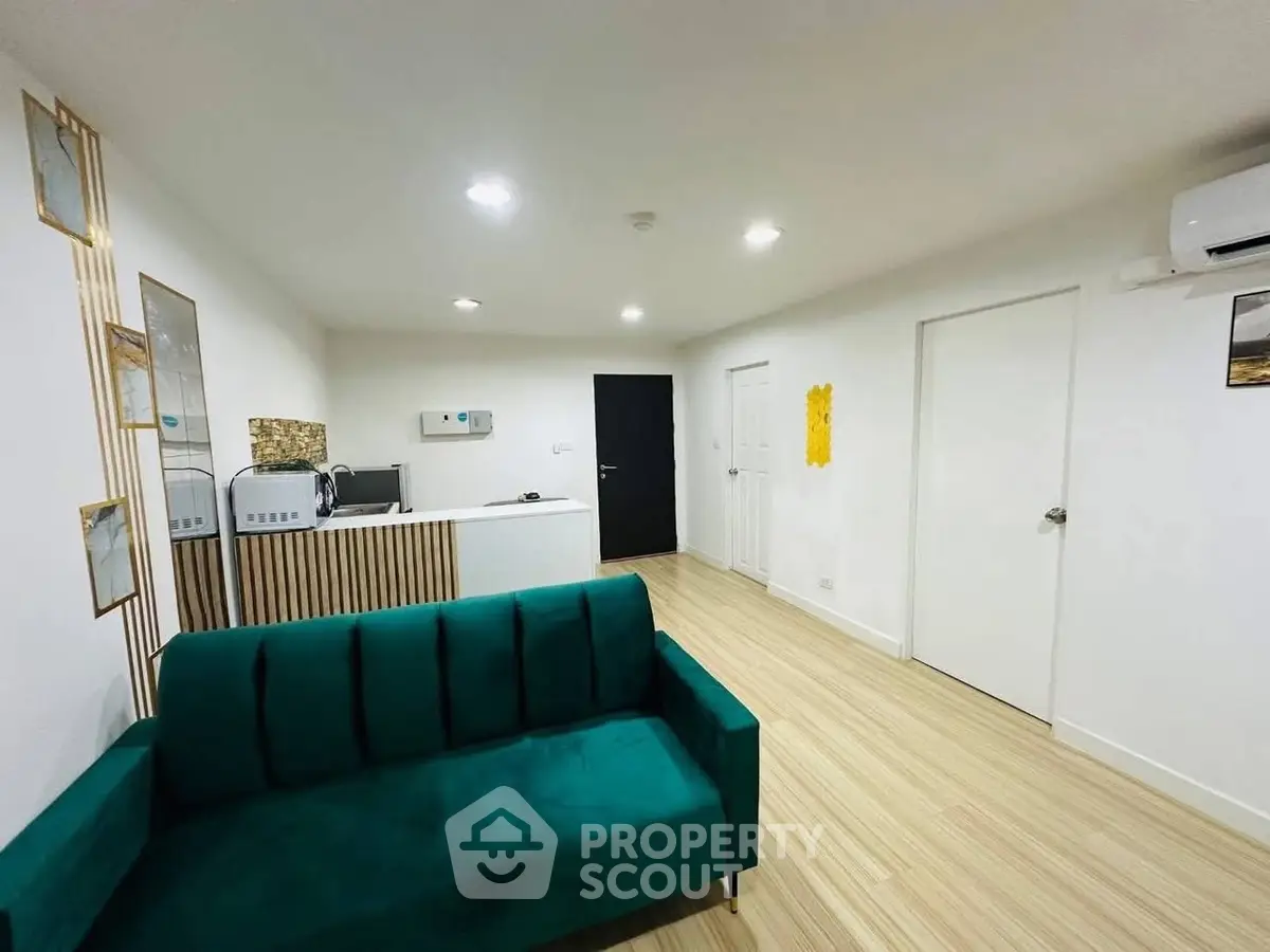 Modern living room with green sofa and minimalist decor