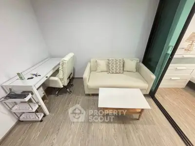 Modern study room with sleek desk, comfortable chair, and cozy sofa in a stylish apartment.