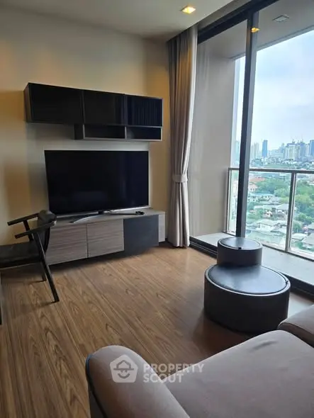 Modern living room with city view and stylish furniture in high-rise apartment