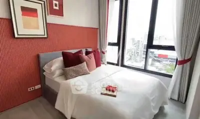 Modern bedroom with city view, stylish decor, and natural light.