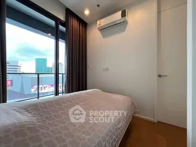 Modern bedroom with city view and air conditioning in urban apartment