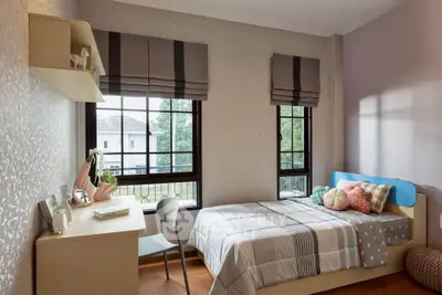 Charming bedroom with cozy decor and natural light, perfect for relaxation and comfort.