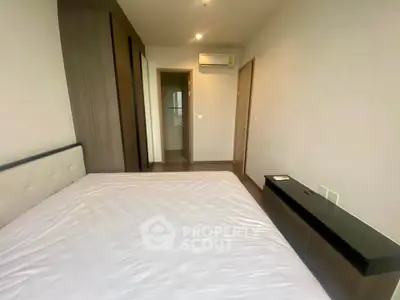 Spacious bedroom with modern furnishings and ample natural light in a contemporary apartment.