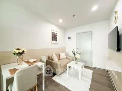 Modern living room with cozy seating and elegant decor in a stylish apartment.