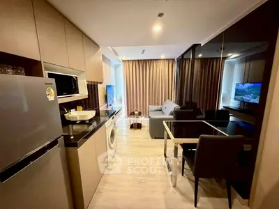 Modern open-layout kitchen and living room with sleek appliances and stylish decor