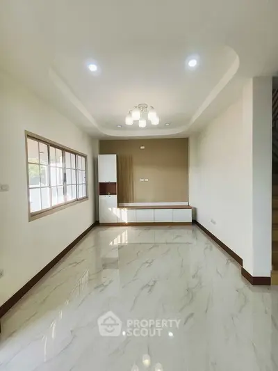 Spacious modern living room with elegant lighting and glossy marble floors