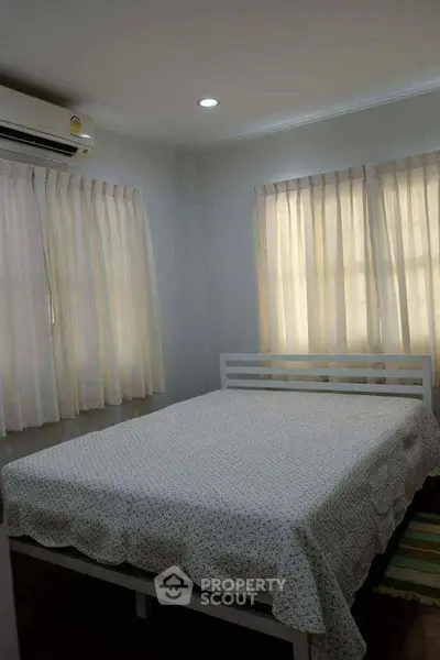 Cozy bedroom with natural light and air conditioning