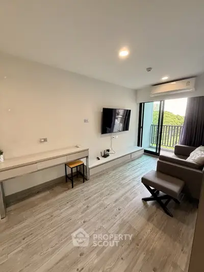 Modern living room with sleek furniture and balcony view in a stylish apartment.
