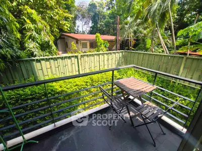 Charming balcony with lush garden view, perfect for relaxing outdoors.
