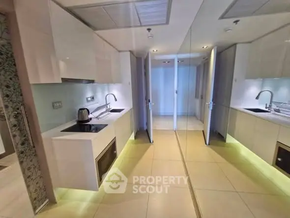 Modern kitchen with sleek design and mirrored cabinets