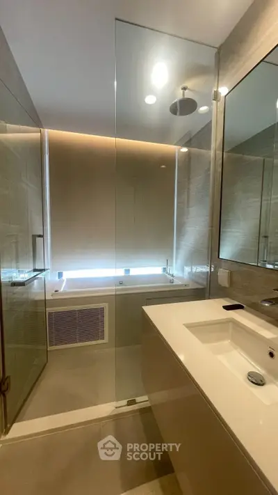 Luxurious modern bathroom with glass shower and elegant fixtures