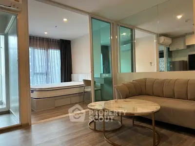 Modern studio apartment with stylish living area and cozy bedroom