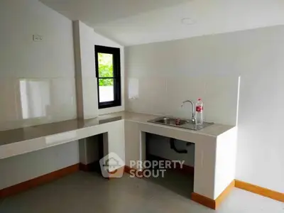 Minimalist kitchen with sleek countertops and modern sink design