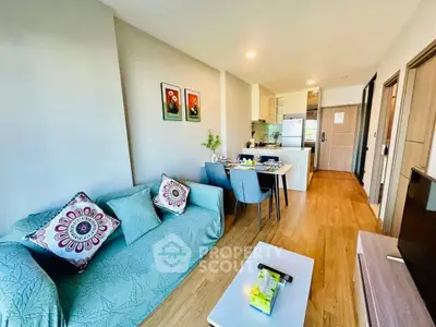Modern open-plan living room with stylish decor and dining area in a cozy apartment.