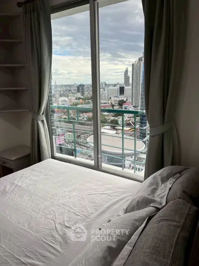 High-rise bedroom with stunning city view through large window, modern and cozy ambiance.