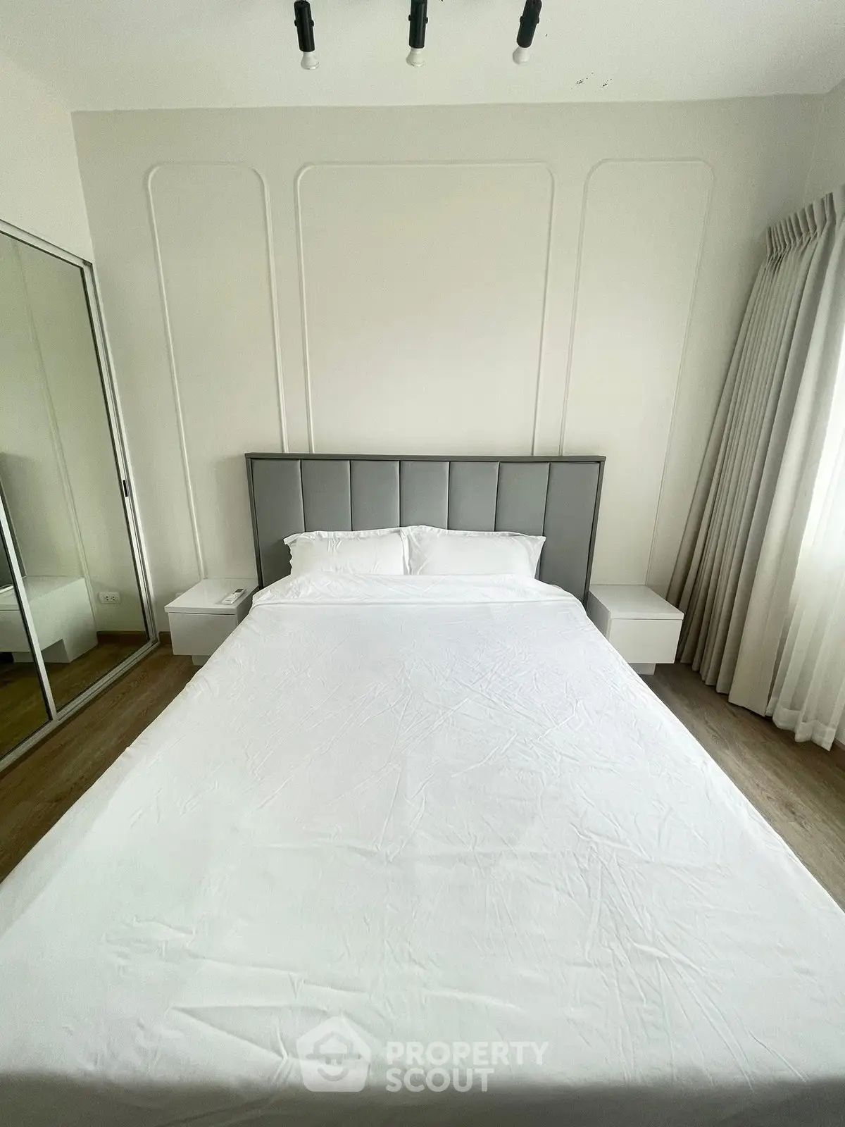 Modern bedroom with sleek design and mirrored closet doors