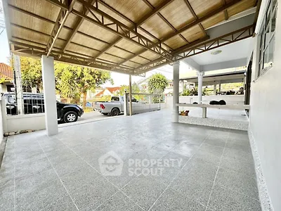 Spacious covered parking area with tiled flooring and open view
