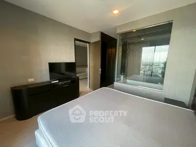 Modern bedroom with city view and sleek furnishings in high-rise apartment