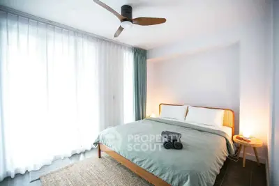 Bright and cozy bedroom with modern decor and large window