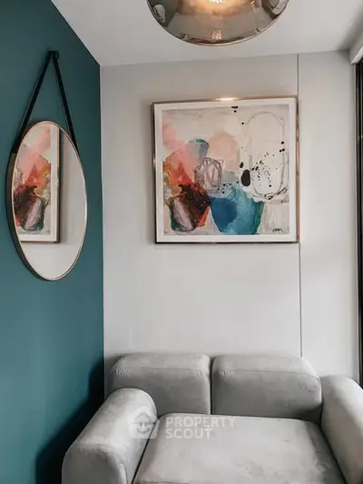 Stylish modern living room corner with abstract art and elegant mirror