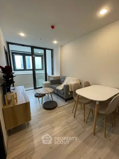 Modern living room with cozy furniture and large windows in a stylish apartment.