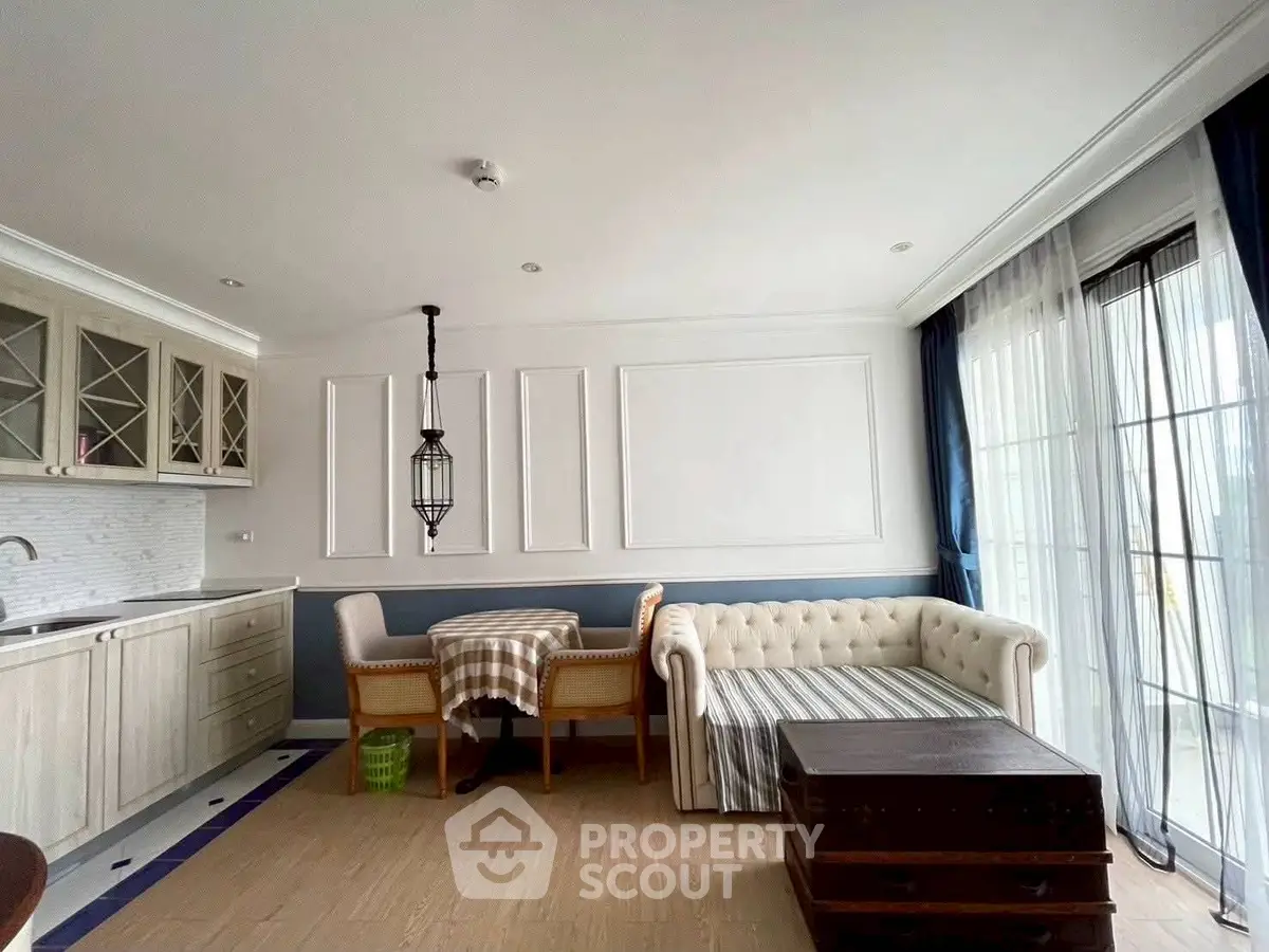 Charming living room with elegant decor and natural light, featuring a cozy sofa and stylish dining area.