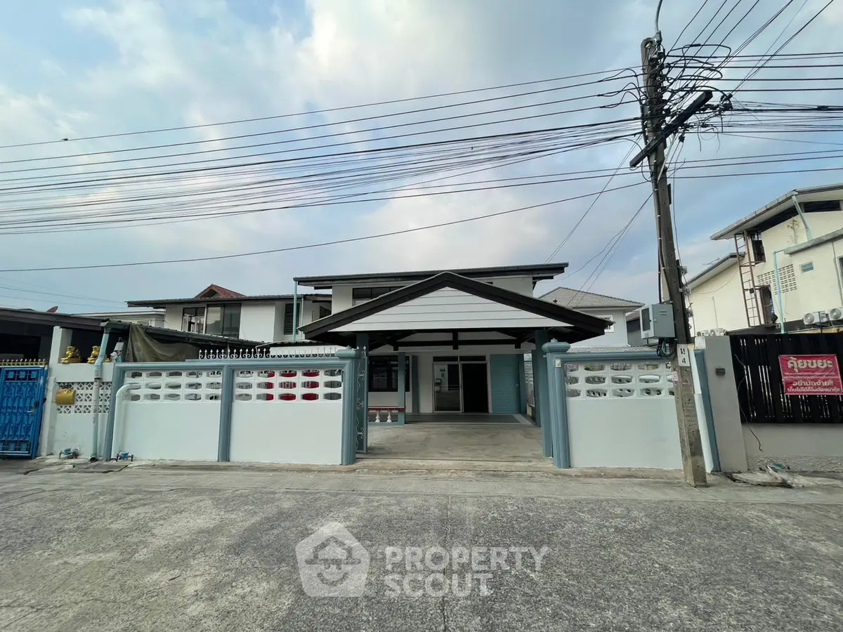 Charming single-story home with spacious driveway and modern facade in a serene neighborhood.