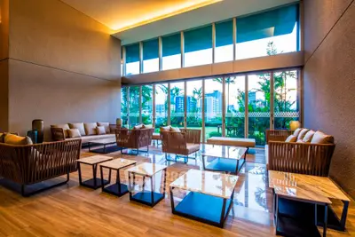 Luxurious modern living room with floor-to-ceiling windows and elegant seating area overlooking a scenic view.