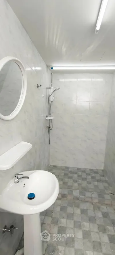 Modern minimalist bathroom with sleek fixtures and tiled walls, perfect for a contemporary home.